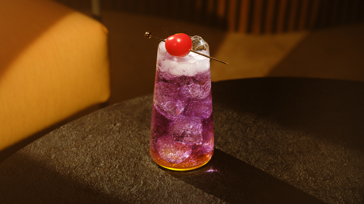 a glass of schweppes passion fruit highball on a table